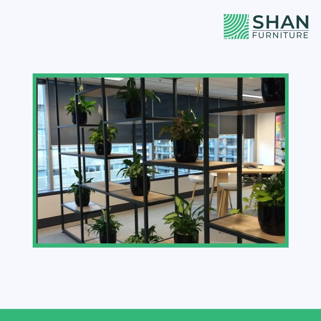 Black metal planter wall room divider with potted plants